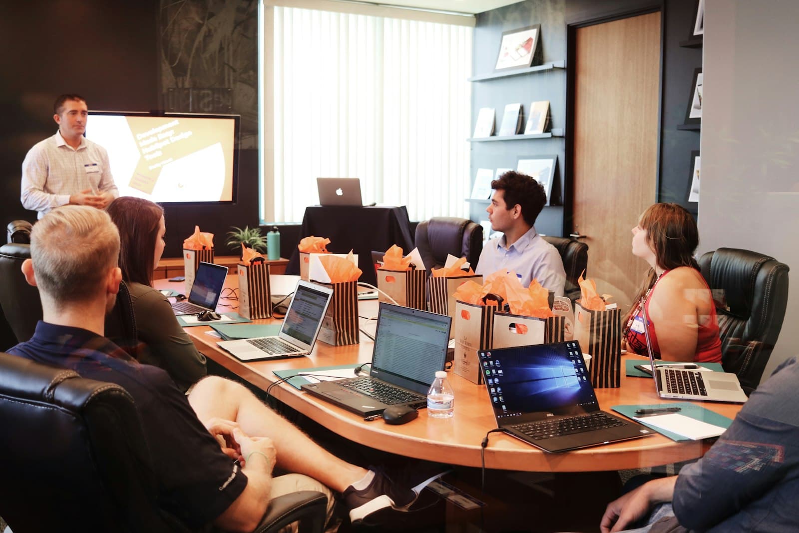 Photo: Campaign Creators, Unsplash A team around a meeting-room table with laptops open